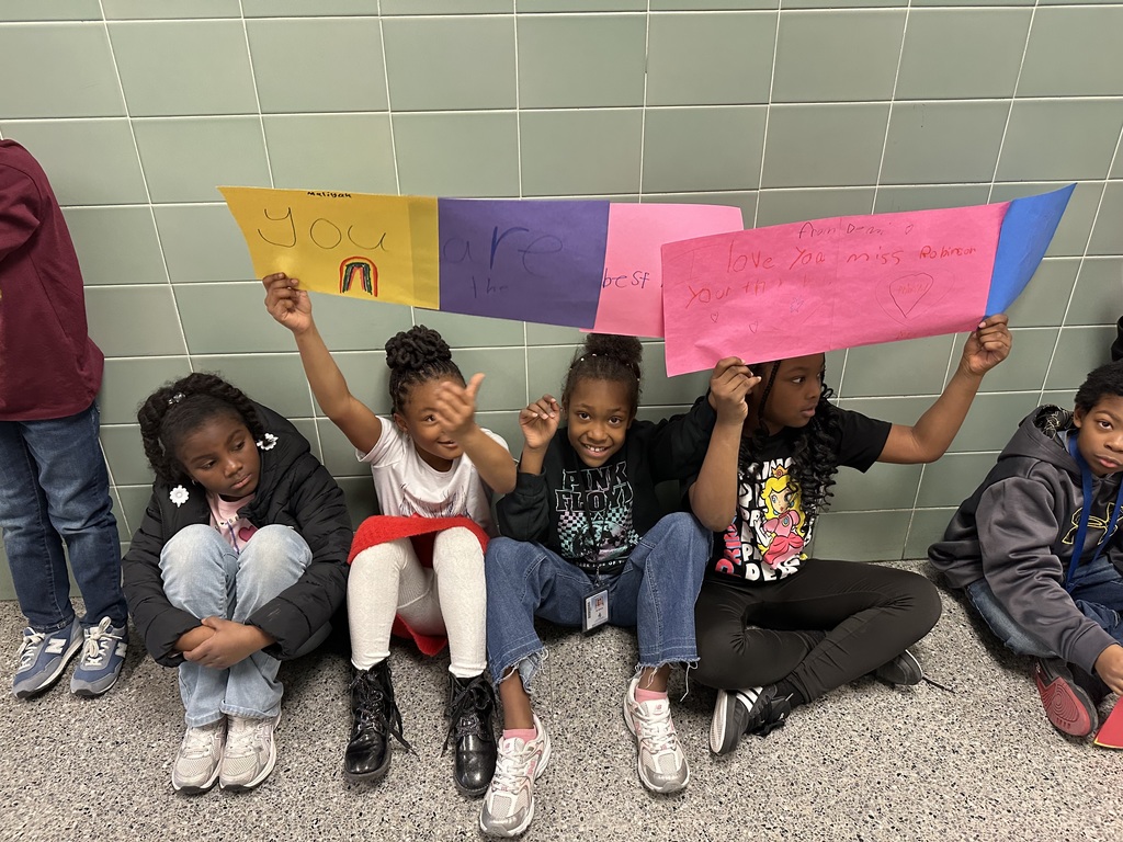 students with signs to celebrate the principal Mrs. robinson