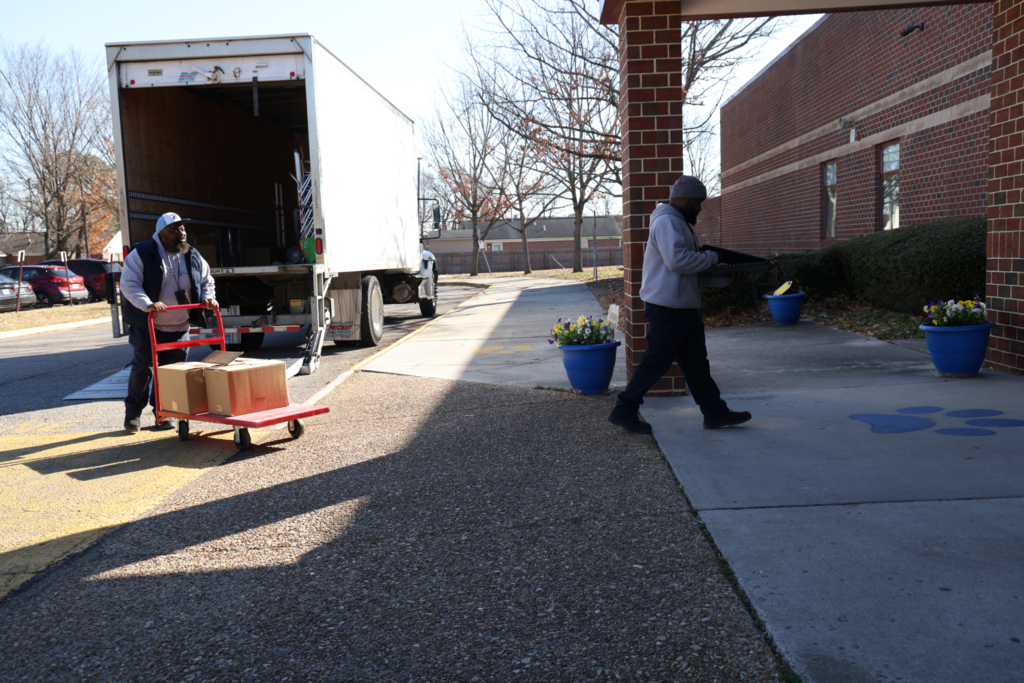 Ron and Emanuel. unloading the truck and rolling in to a school