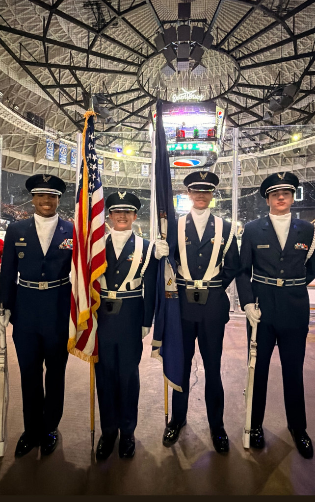 Pic of ROTC students presenting colors at hockey game