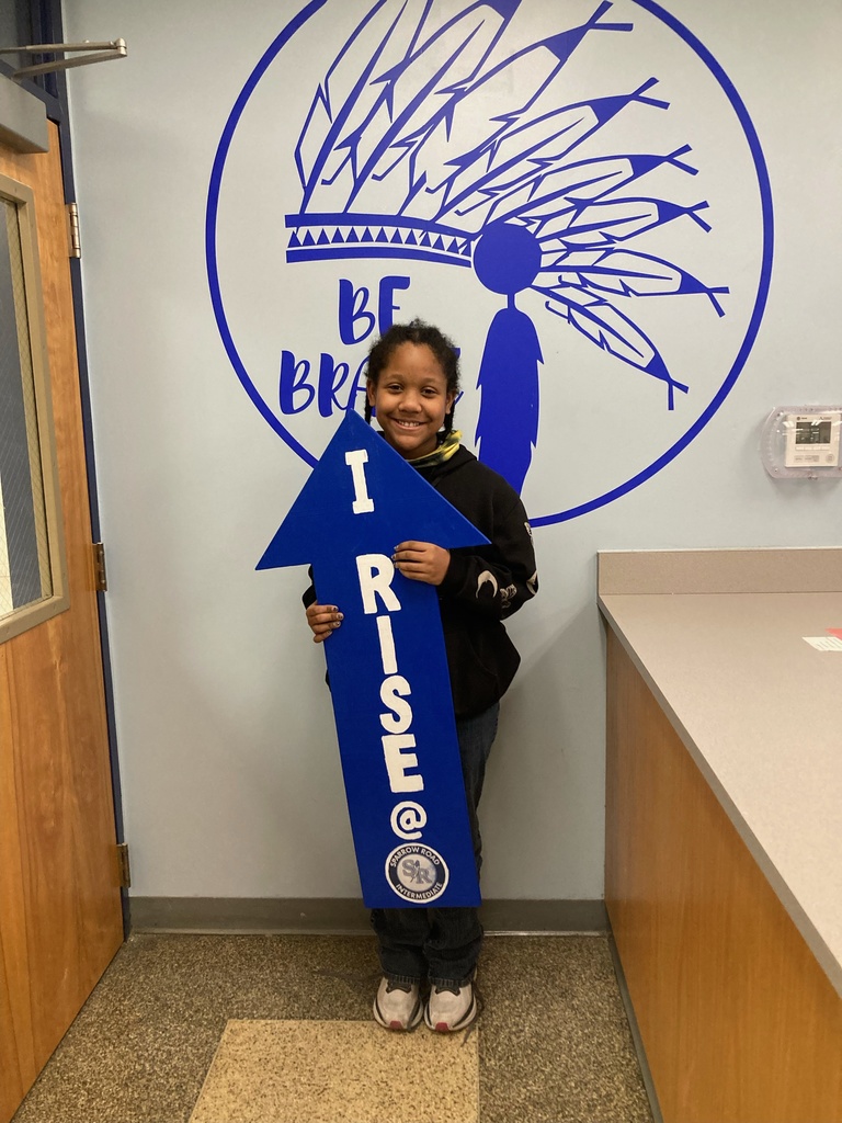 Student holding the RISE arrow