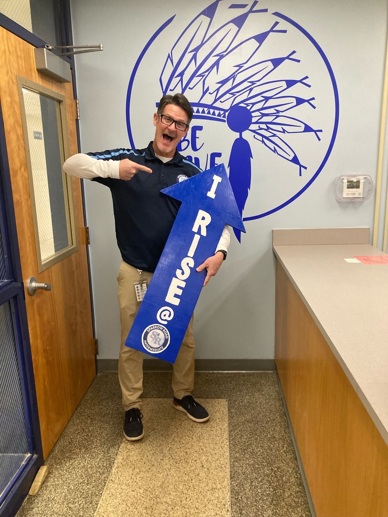 Mr. Triolet holding the RISE arrow