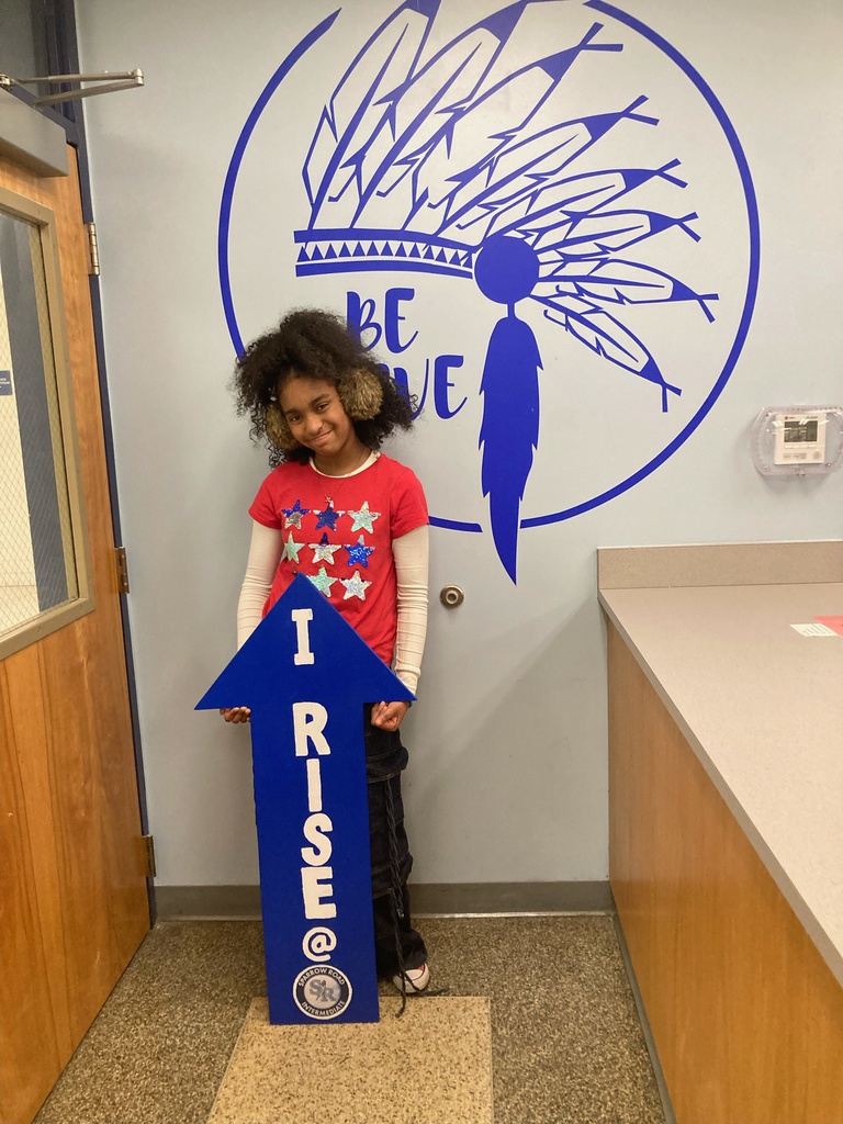 Student holding the RISE arrow