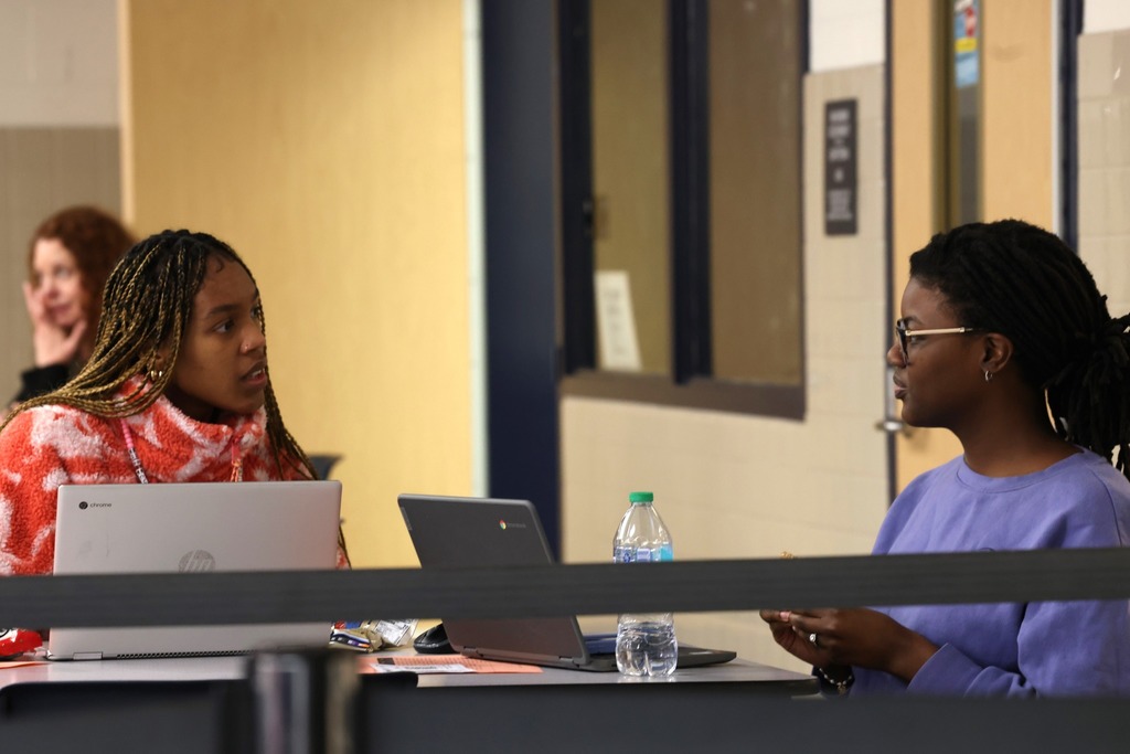 two female teachers speking at table