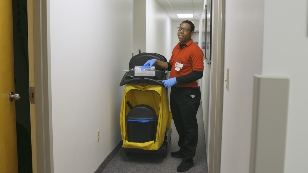 young man with custodial cart