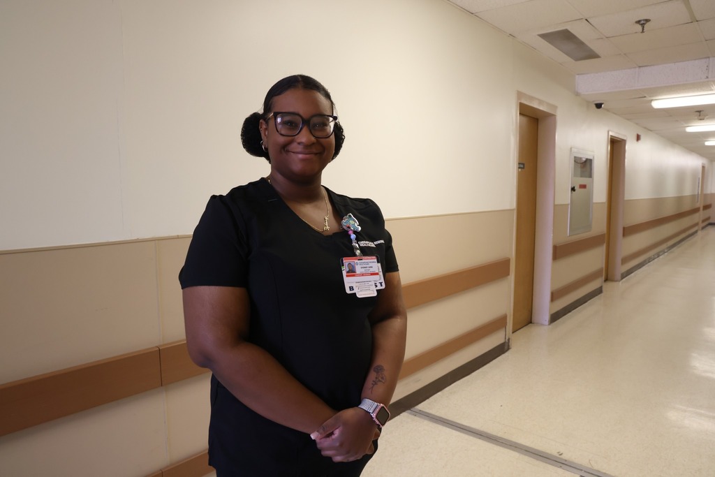 young woman smling in hallway