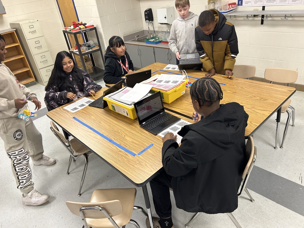 Two groups working on their LEGO investigation.