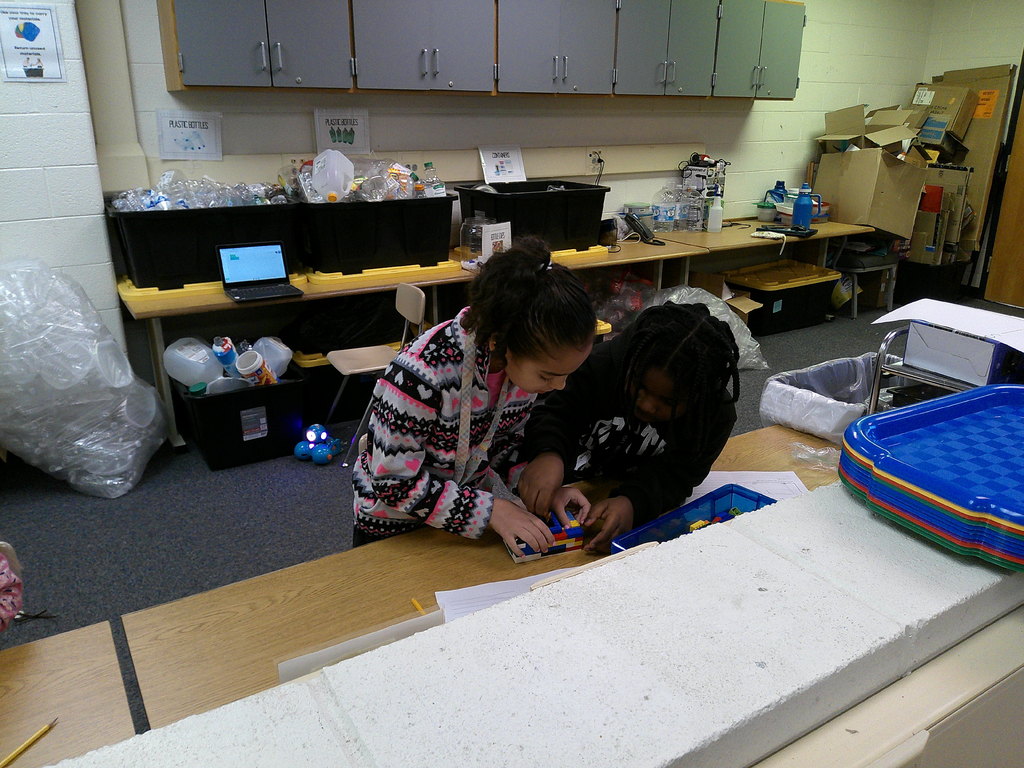 students work in partners to build an animal transportation structure