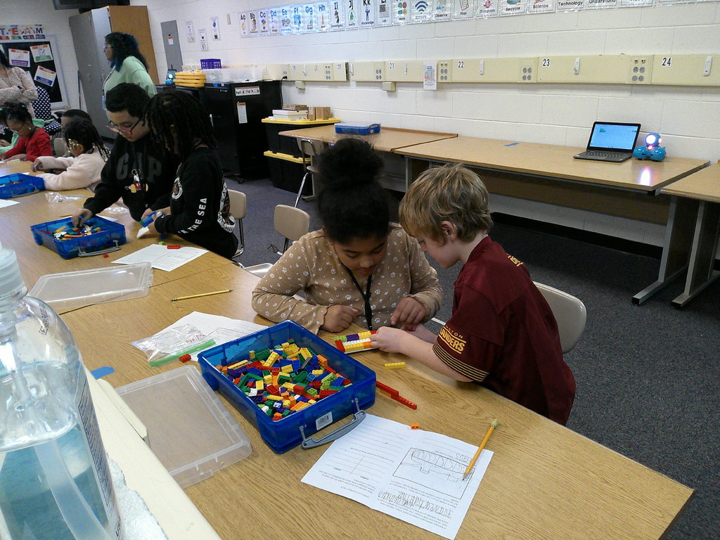 students work in partners to build an animal transportation structure