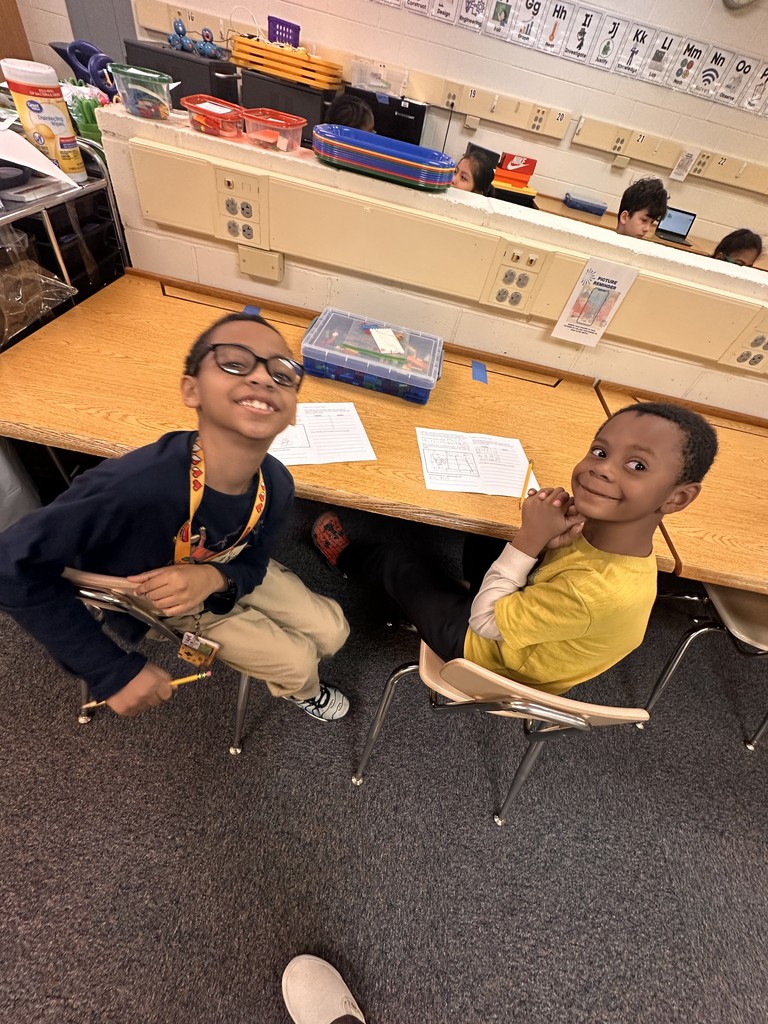 students work in partners to build an animal transportation structure