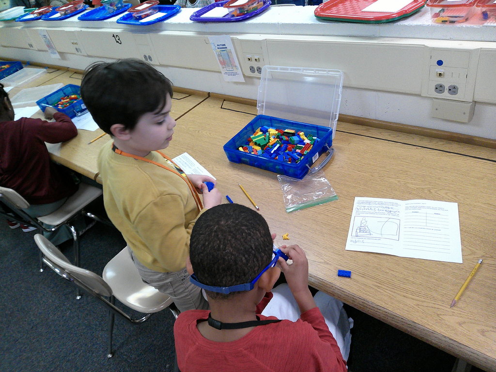 students work in partners to build an animal transportation structure