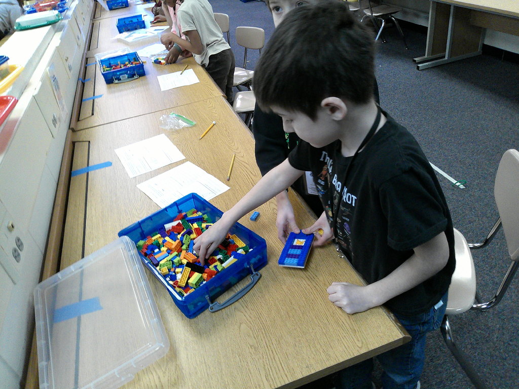 students work in partners to build an animal transportation structure