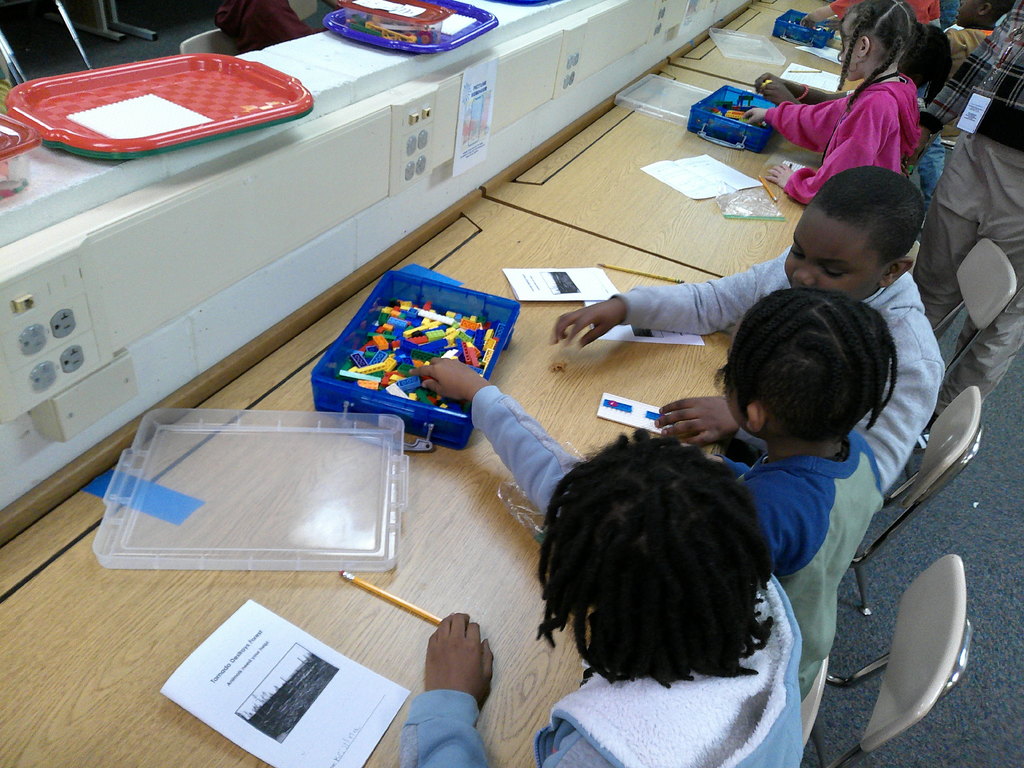 students work in partners to build an animal transportation structure