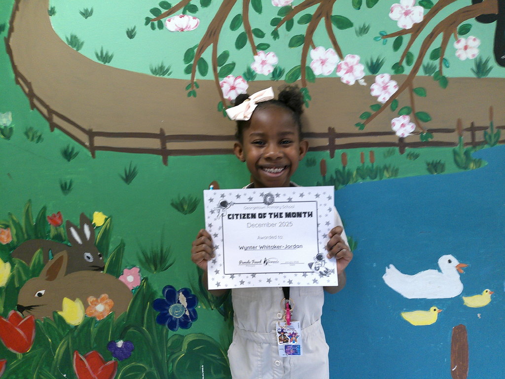 Wynter Whitaker-Joran holding her Citizen of the Month certificate