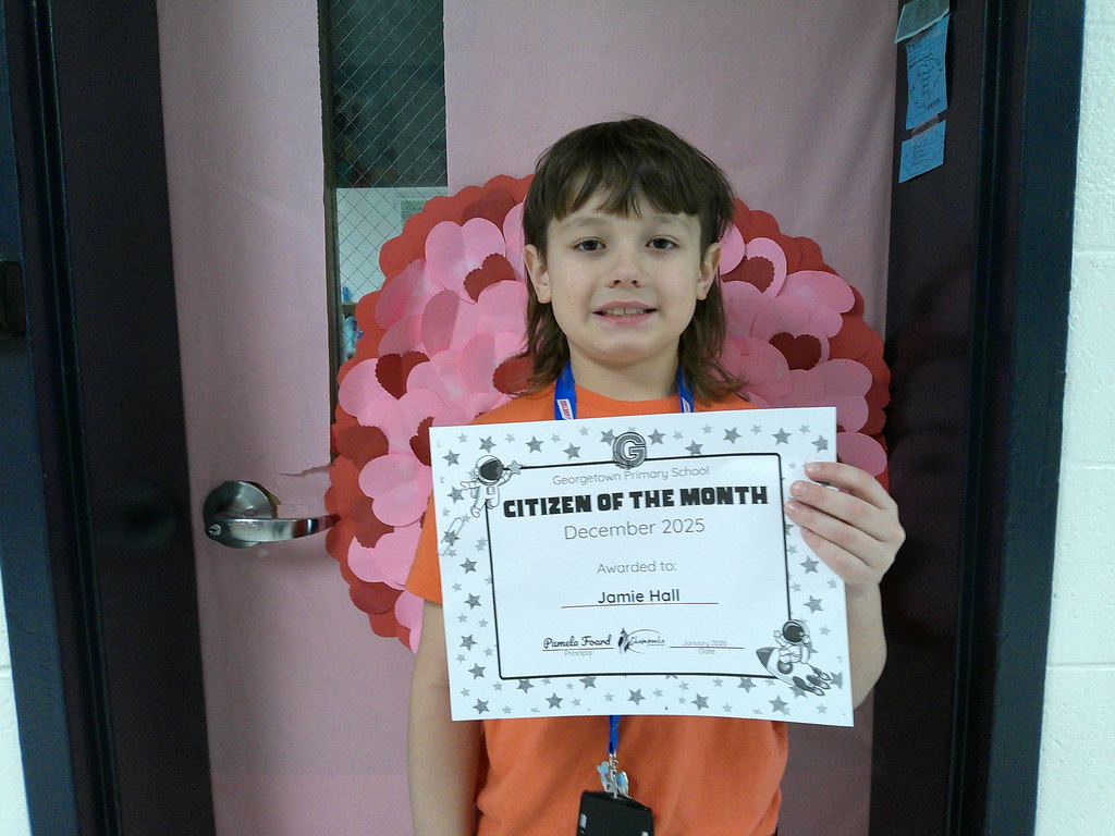 Jamie Hall holding his Citizen of the Month certificate