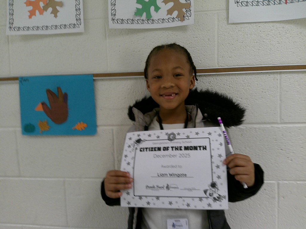 Liam Wingate holding his Citizen of the Month certificate