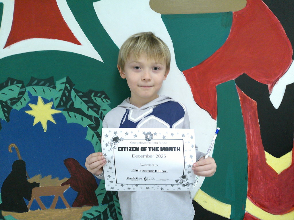 Christopher Killian holding his Citizen of the Month certificate