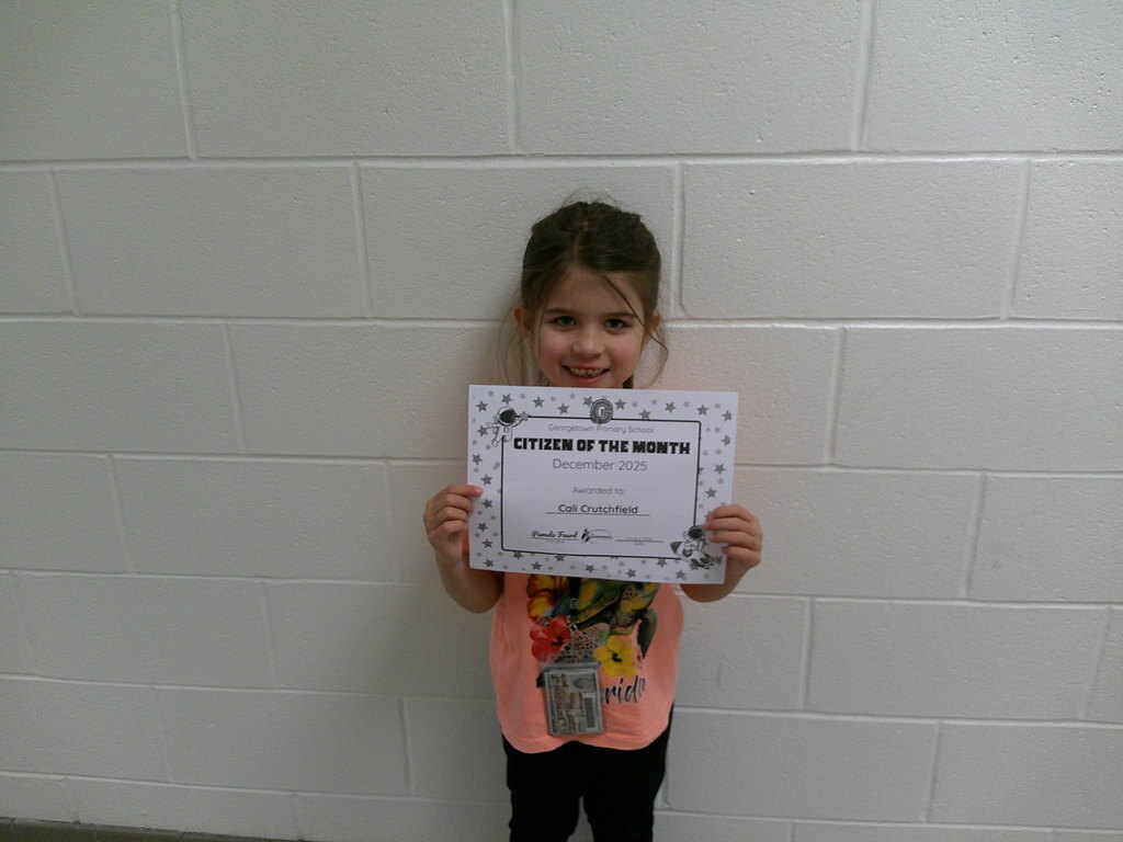 Cali Crutchfield holding her Citizen of the Month certificate