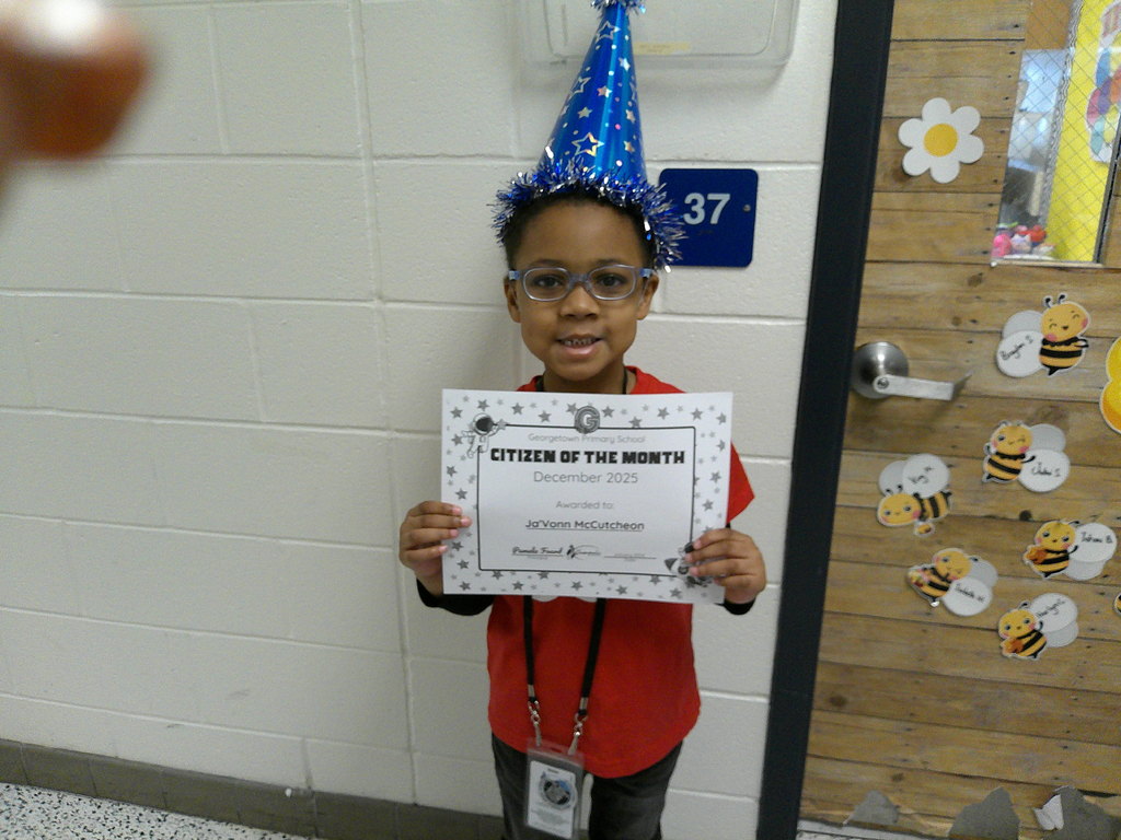 Ja'Vionn McCutcheon holding her Citizen of the Month certificate