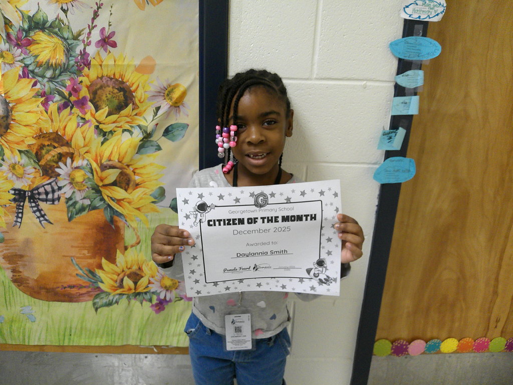 Daylannia Smith holding her Citizen of the Month certificate