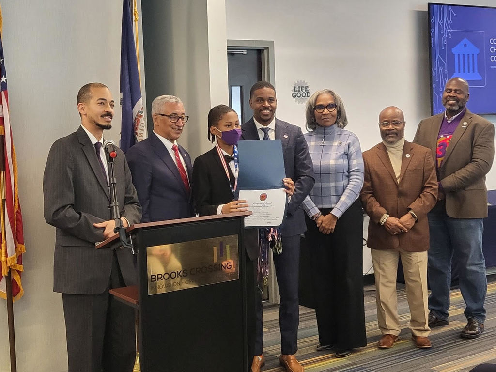 student with award and adults with bobby scott smiling for camera