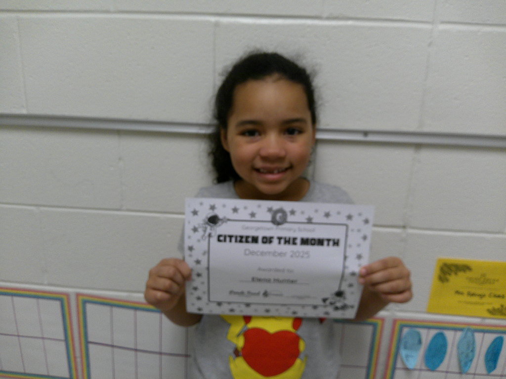 Elena Hunter holding her Citizen of the Month certificate