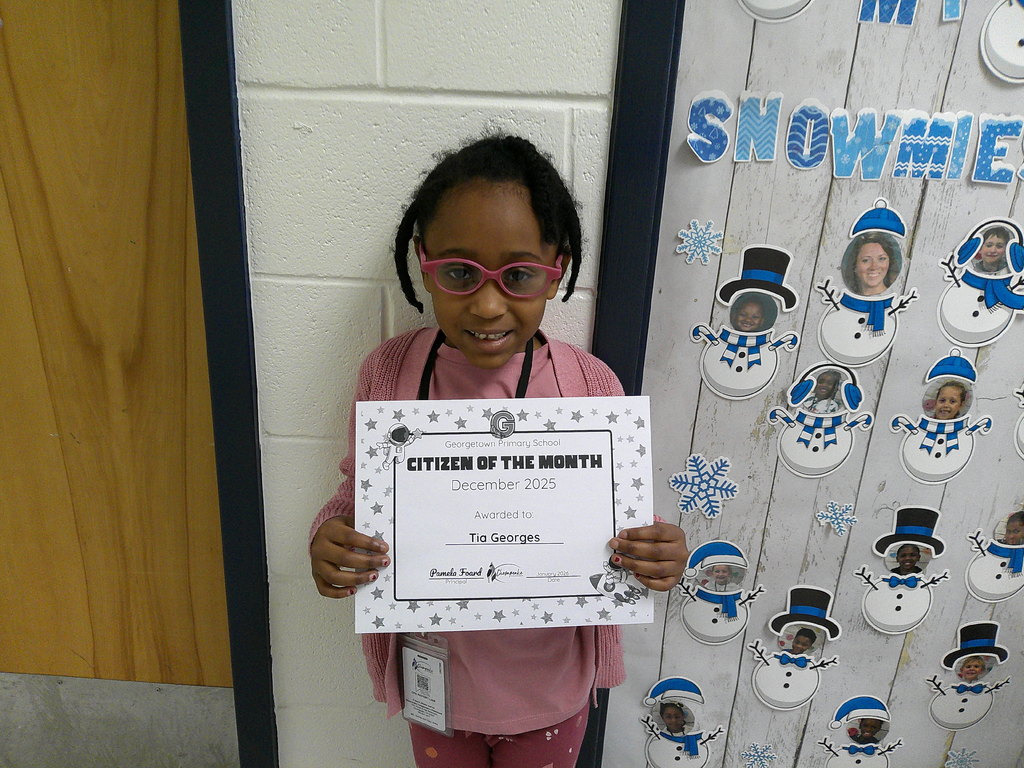 Tia Georges holding her Citizen of the Month certificate