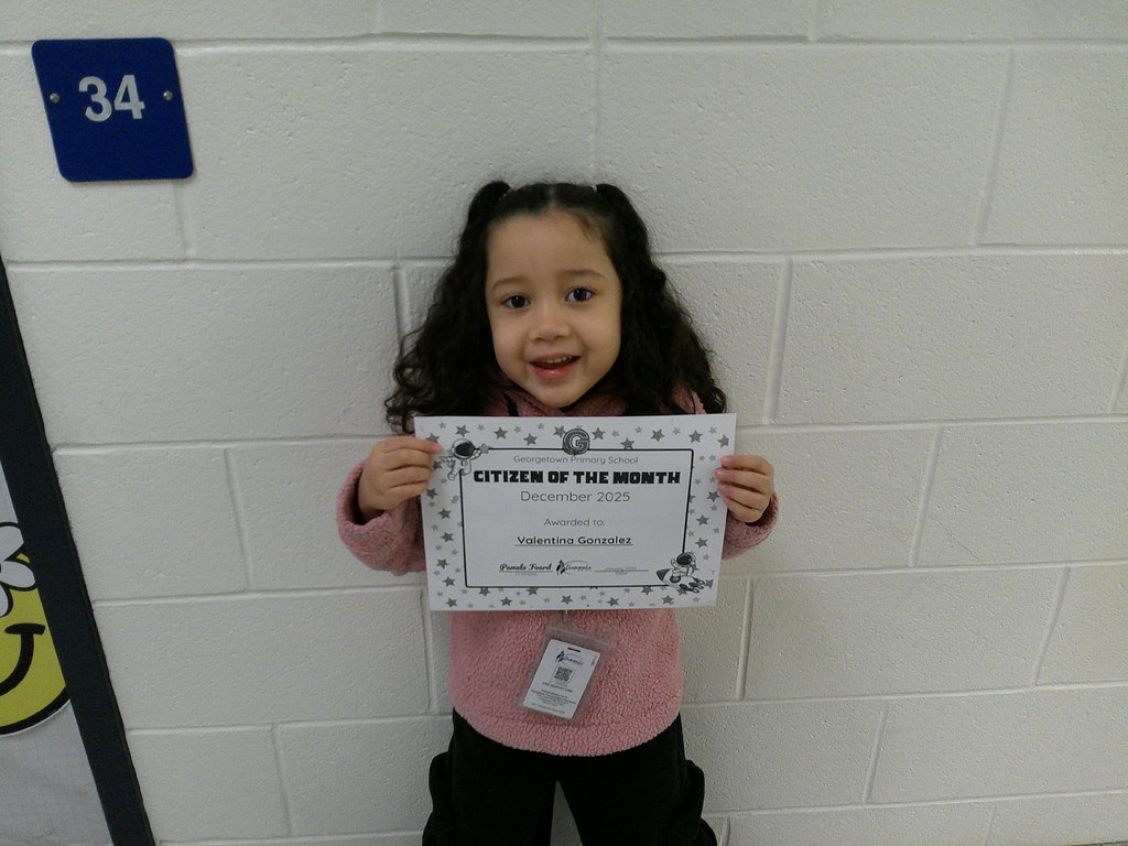 Valentina Gonzalez holding her Citizen of the Month certificate