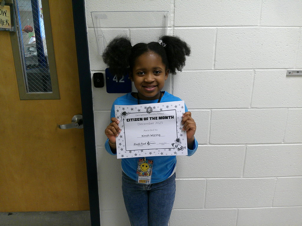 Kinah Waring holding her Citizen of the Month certificate