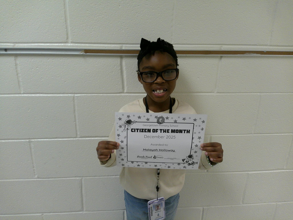 Malayah Holloway  holding her Citizen of the Month certificate