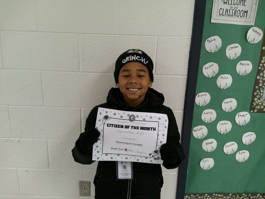 Dominique Cooper holding his Citizen of the Month certificate