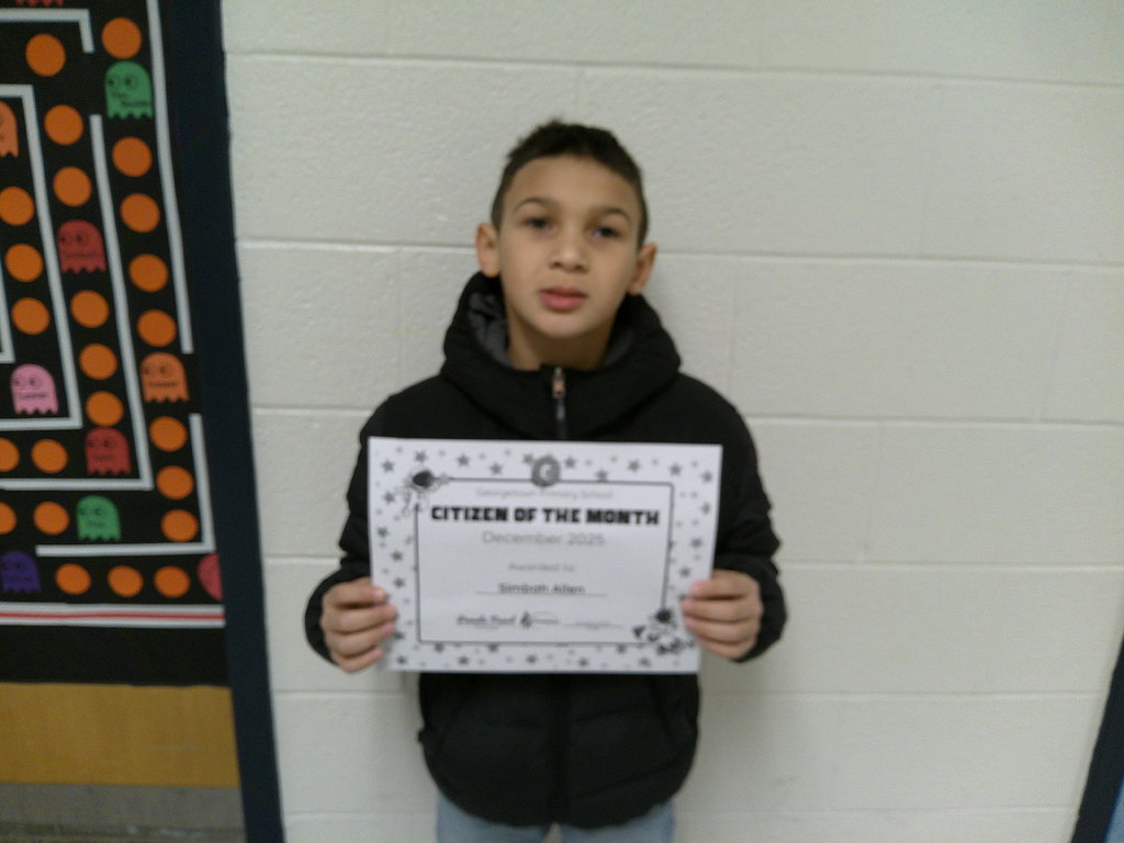 Simbah Allen holding his Citizen of the Month certificate