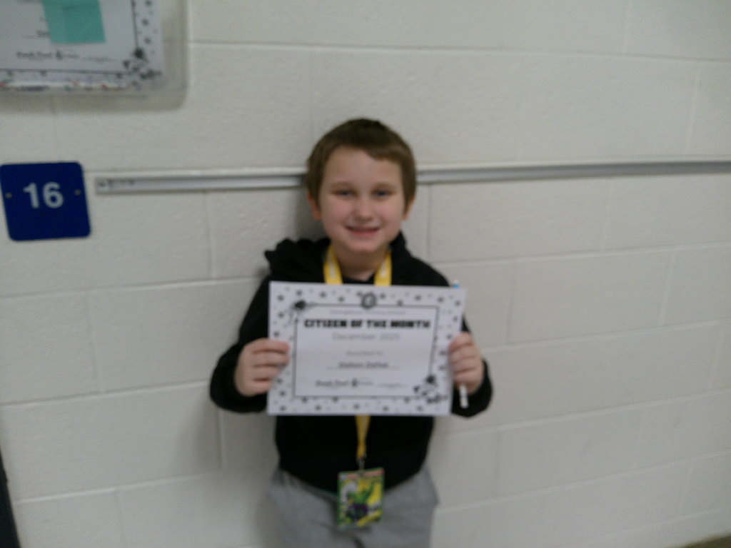 Dalton Dafoe holding his Citizen of the Month certificate
