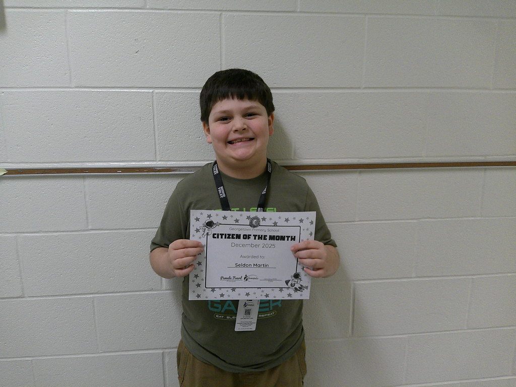 Seldon Martin holding his Citizen of the Month certificate