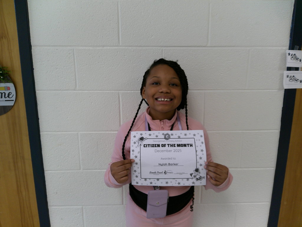 Nylah Barker holding her Citizen of the Month certificate