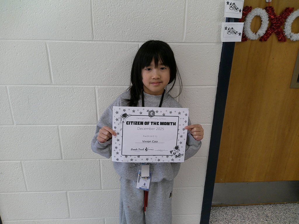 Vivian Cao holding her Citizen of the Month certificate