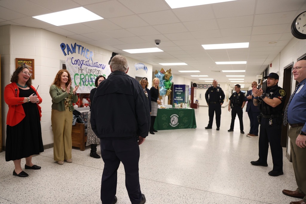 Mr. Compton entering school back shot with adults cheering