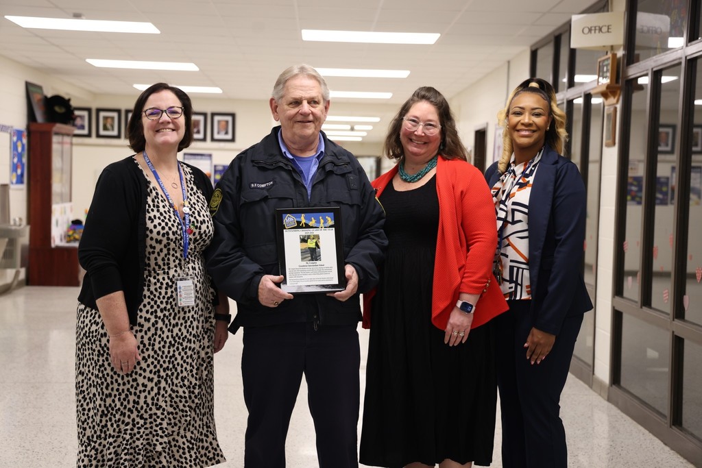 Mr. Compton smiling with 3 female principals from GRI