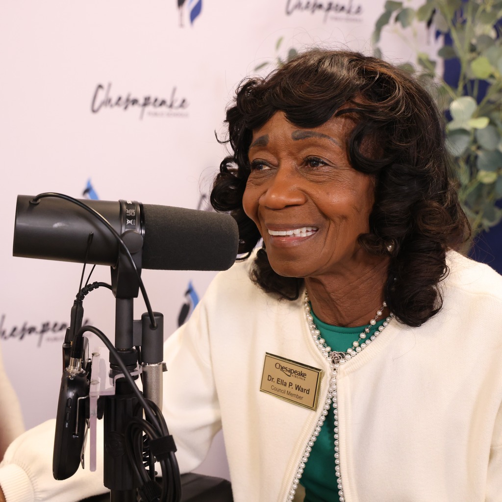 City Council Member Dr. Ella Ward smiling in a podcast studio.