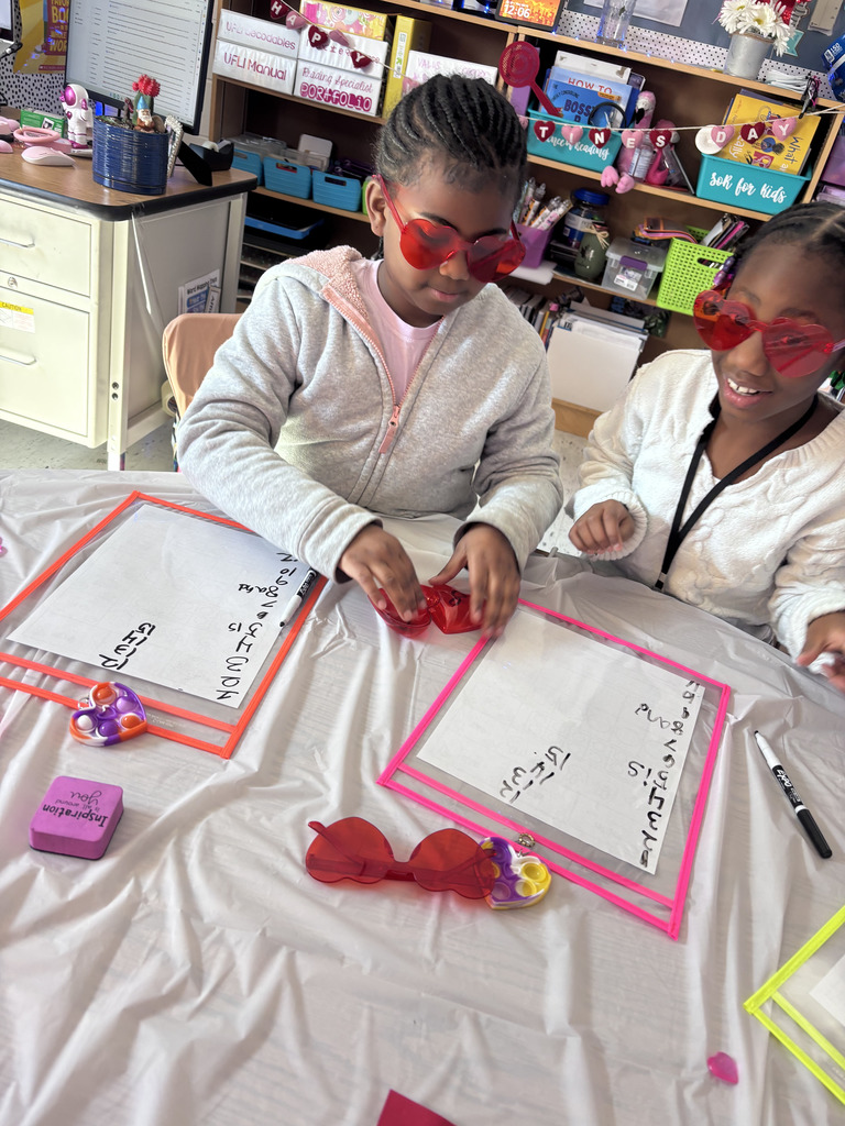 first grade students wear heart glasses as they practice their heart words with Mrs Chris man, the reading specialist