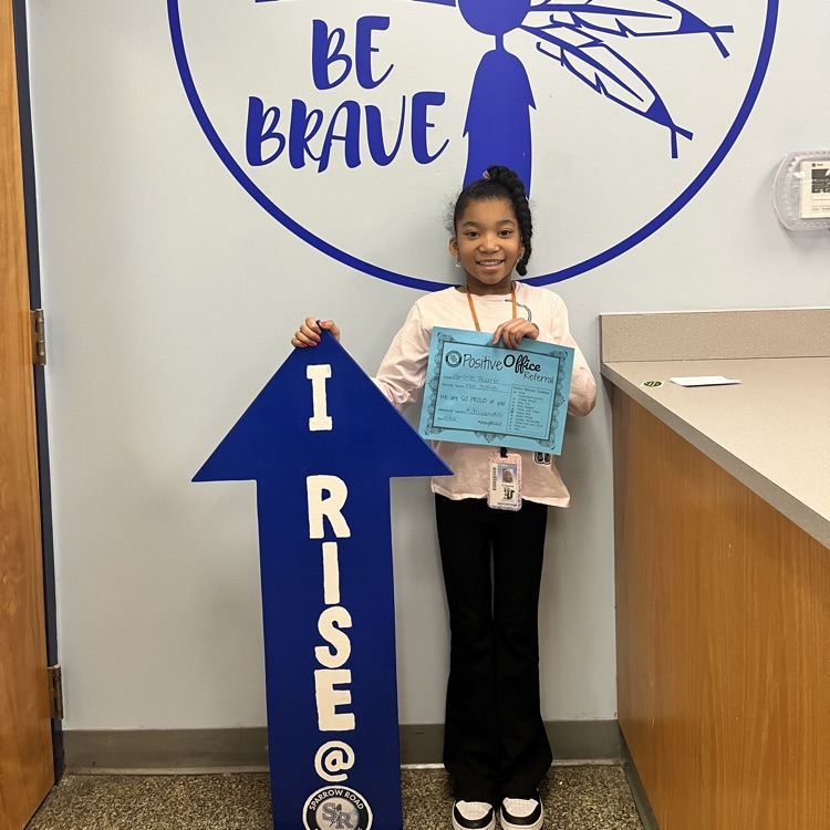 Student with Positive Behavior Referral Certificate and I RISE arrow
