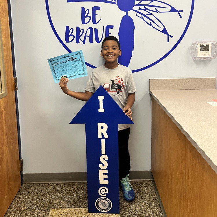 Student with Positive Behavior Referral Certificate and I RISE arrow