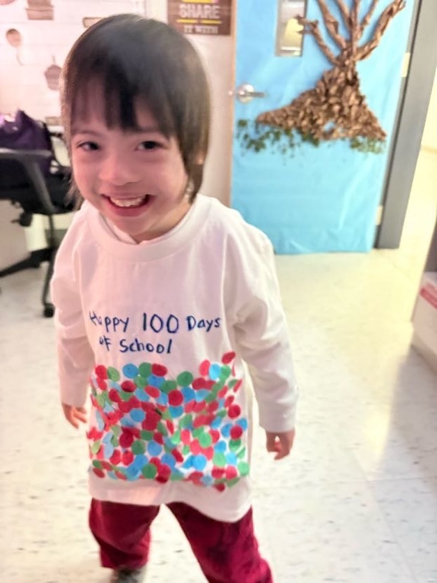 student wearing a homemade 100th day of school shirt