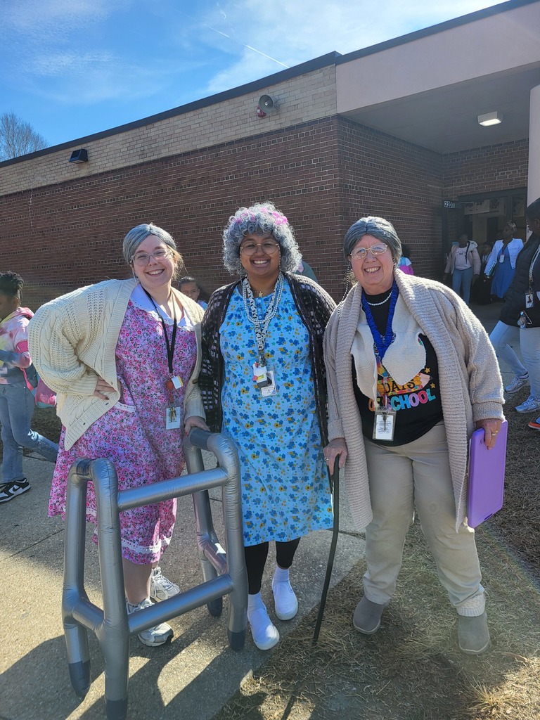 three staff members dressed as 100 year old women for the 100th day of school