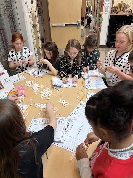 Students completing a 101 dalmatian-themed STEM challenge on the 101st day of school