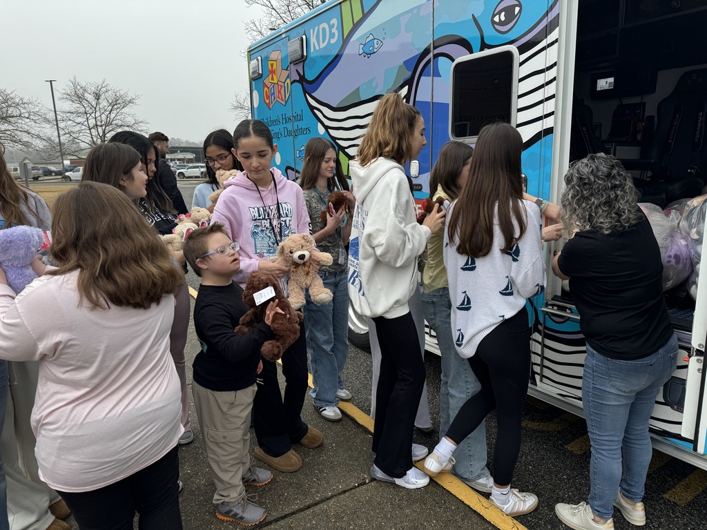 students with CHKD ambulance and the teddy bear donations