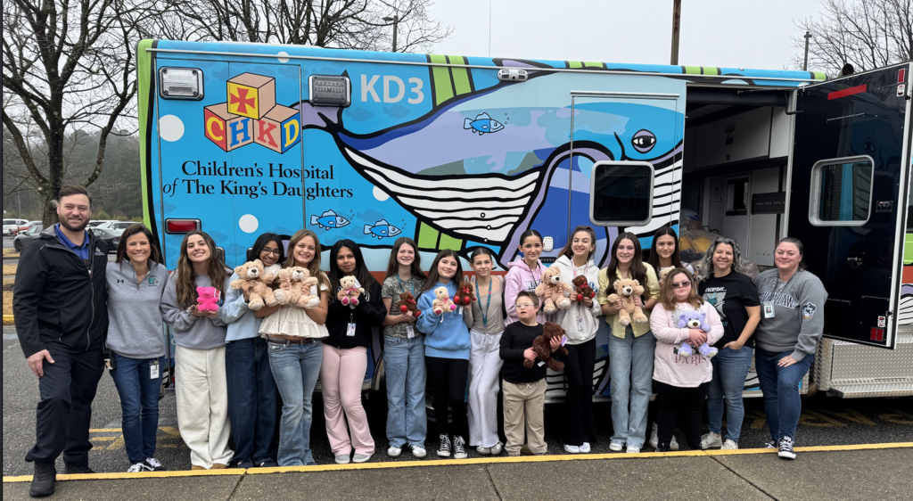 students with CHKD ambulance and the teddy bear donations