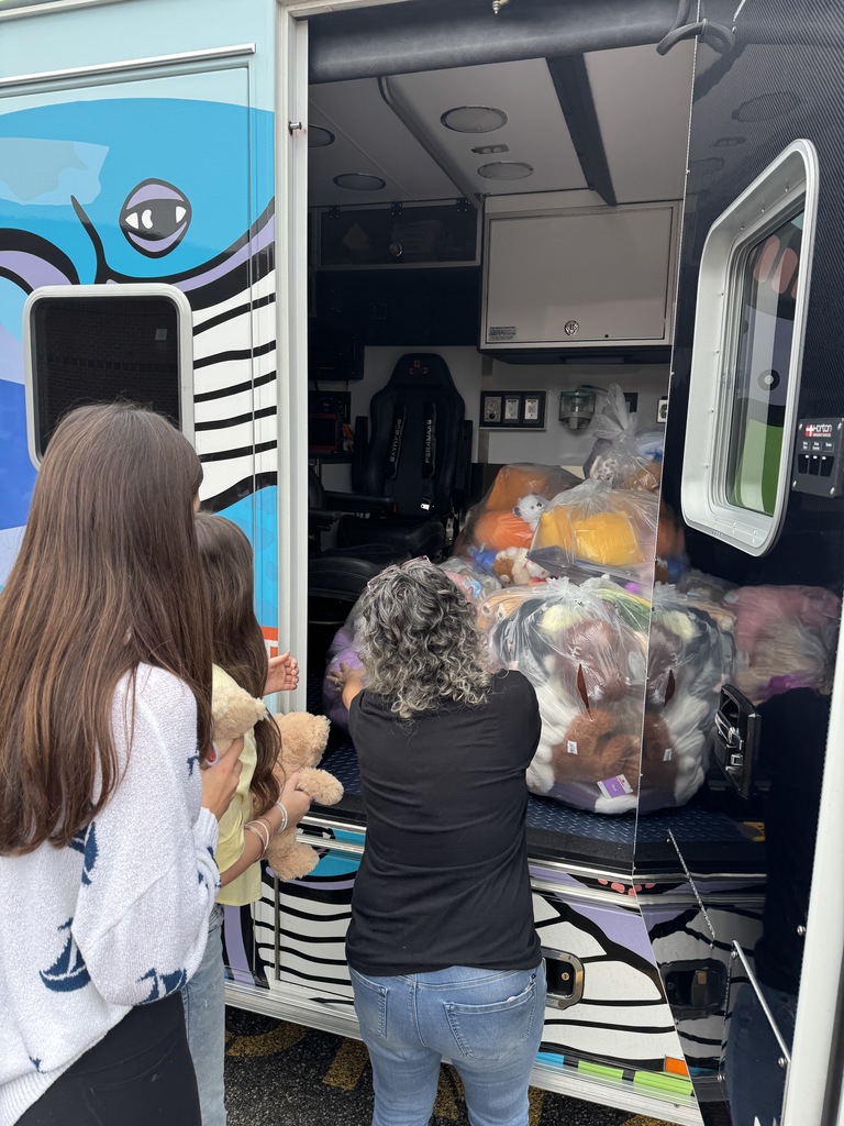 students with CHKD ambulance and the teddy bear donations