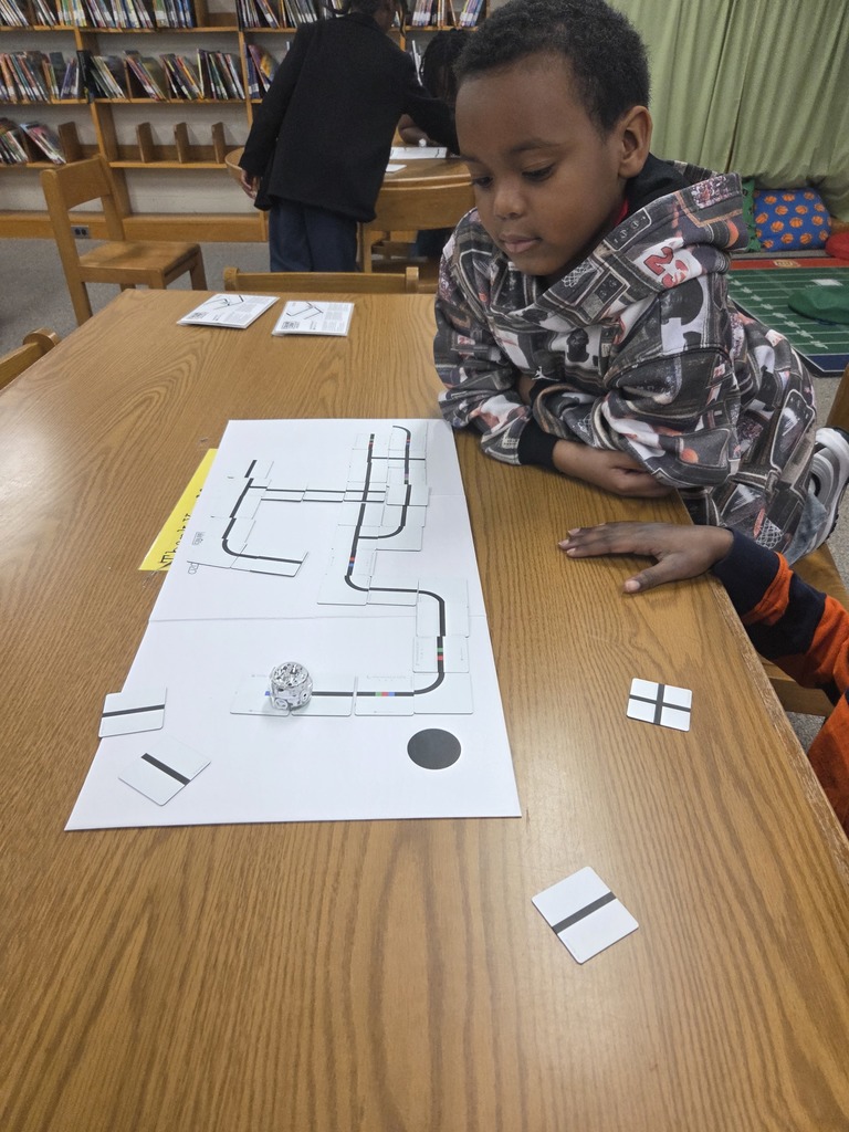 Students using Ozobot and magnet tiles to code.