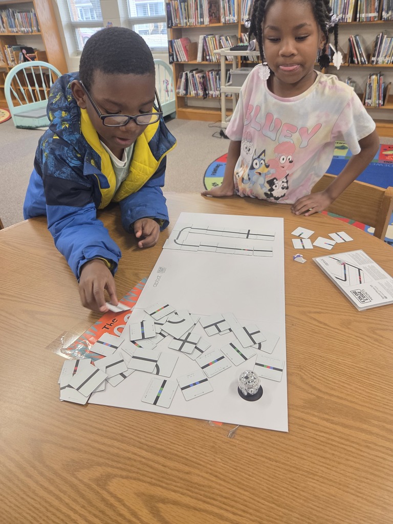 Students using Ozobot and magnet tiles to code.