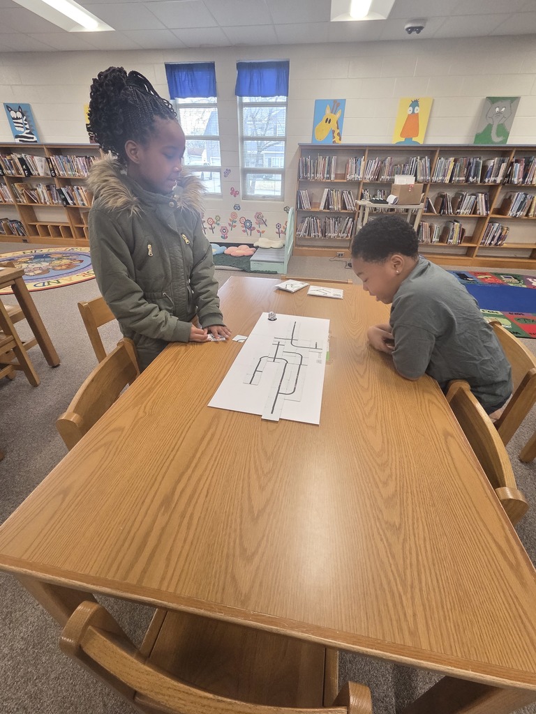 Students using Ozobot and magnet tiles to code.